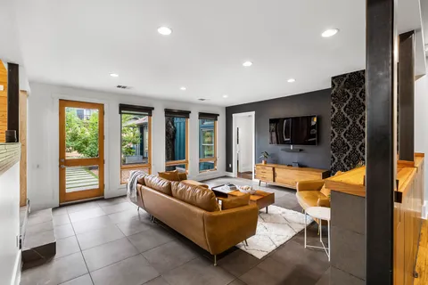a living room with patio furniture and a large window