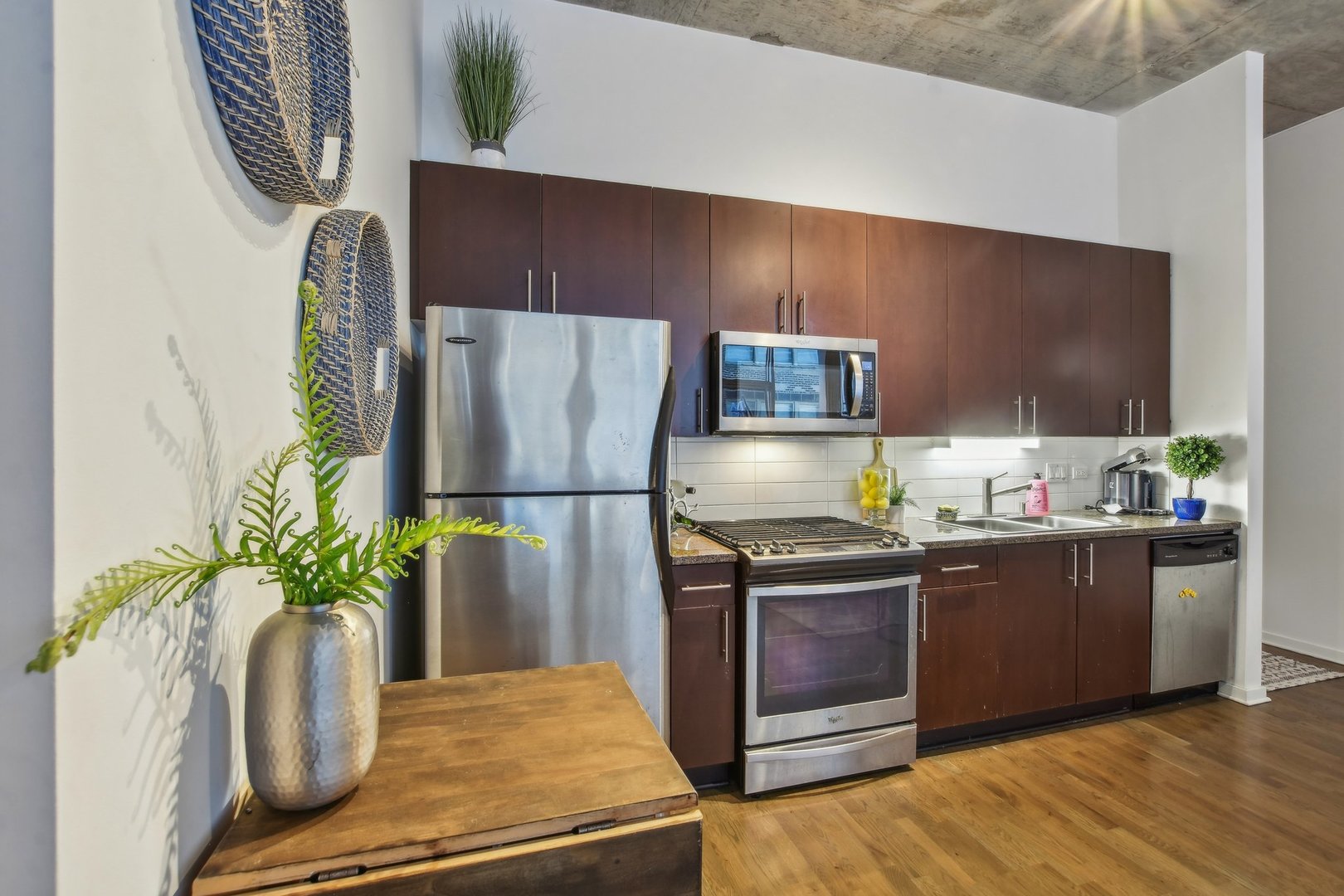 611 South Wells Street, Unit 702 Chicago, IL 60607 - Photo 12 of 32 a kitchen with stainless steel appliances a refrigerator a stove a sink and a potted plant
