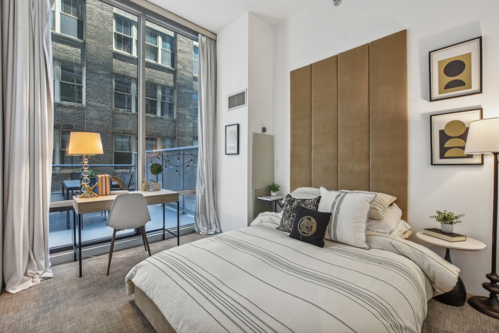 611 South Wells Street, Unit 702 Chicago, IL 60607 - Photo 14 of 32 a bedroom with a bed and a table in it