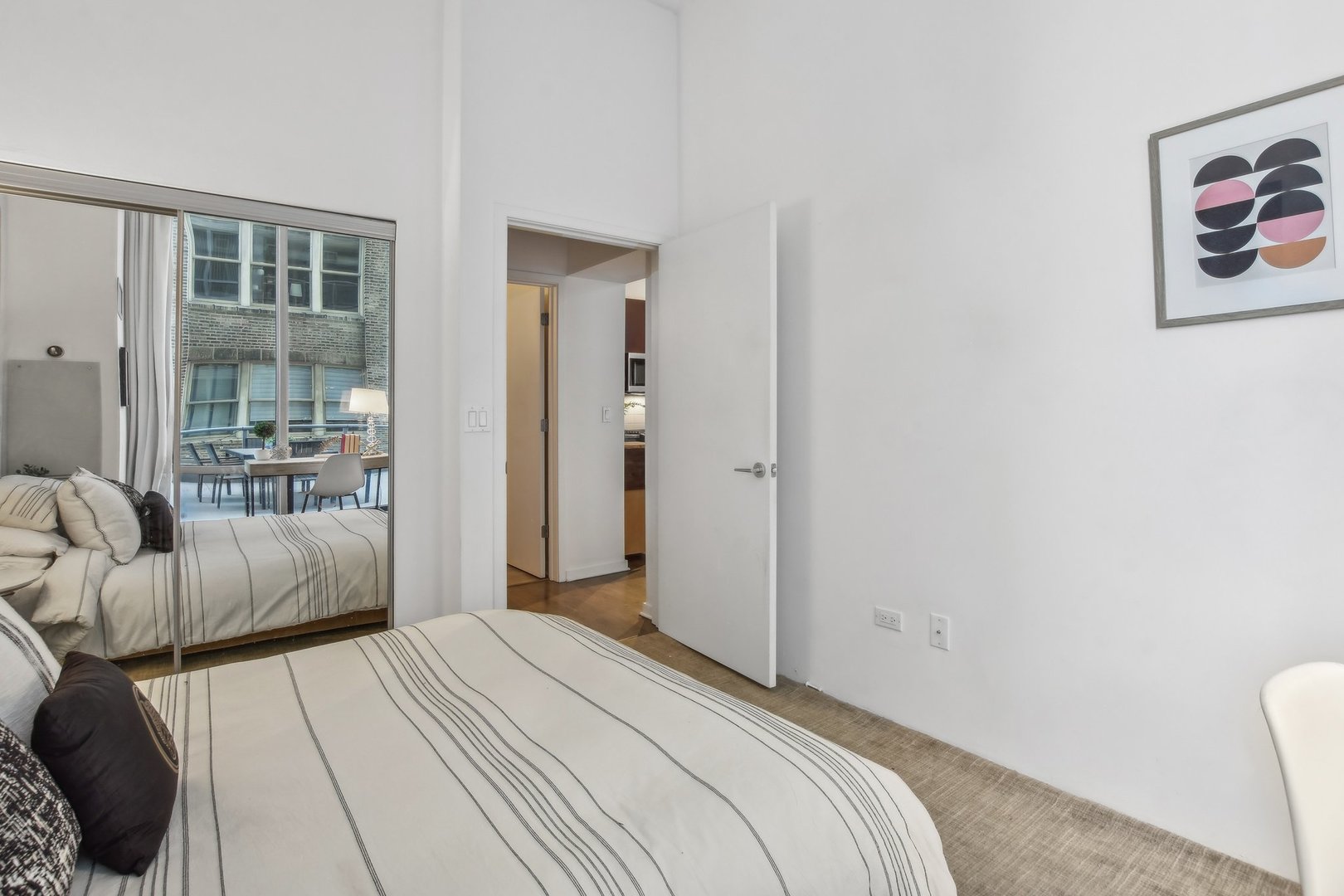 611 South Wells Street, Unit 702 Chicago, IL 60607 - Photo 16 of 32 a bedroom with a bed and a couch