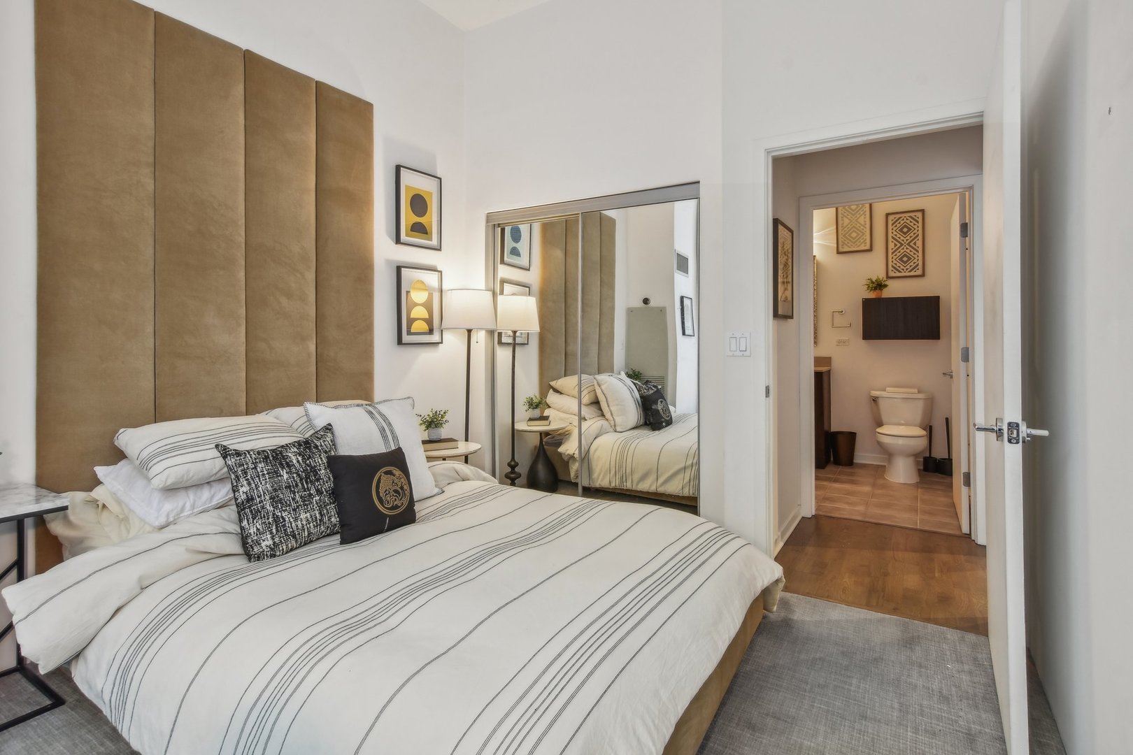 611 South Wells Street, Unit 702 Chicago, IL 60607 - Photo 17 of 32 a bedroom with a bed and a view of bathroom