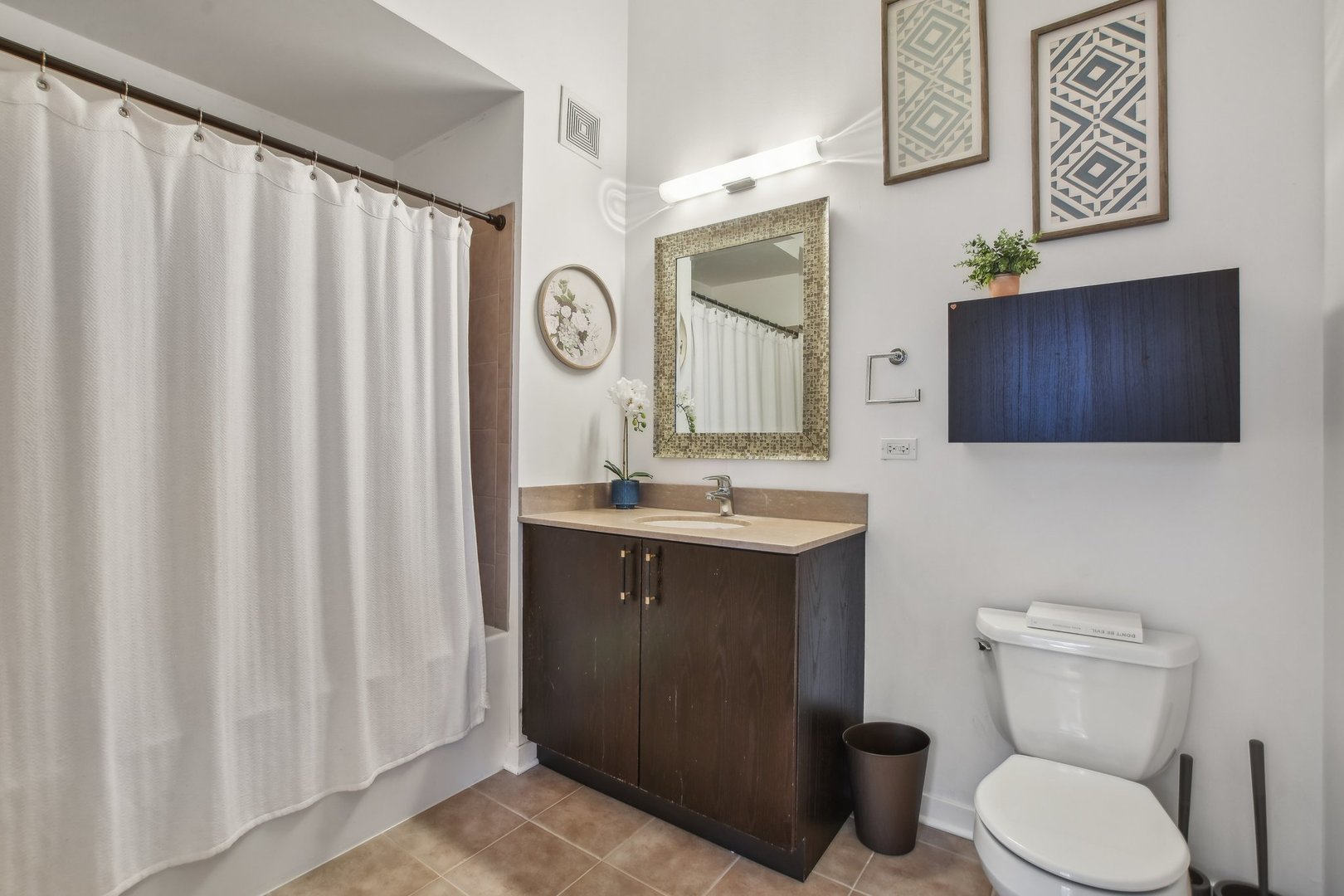 611 South Wells Street, Unit 702 Chicago, IL 60607 - Photo 18 of 32 a bathroom with a toilet a sink and a large mirror
