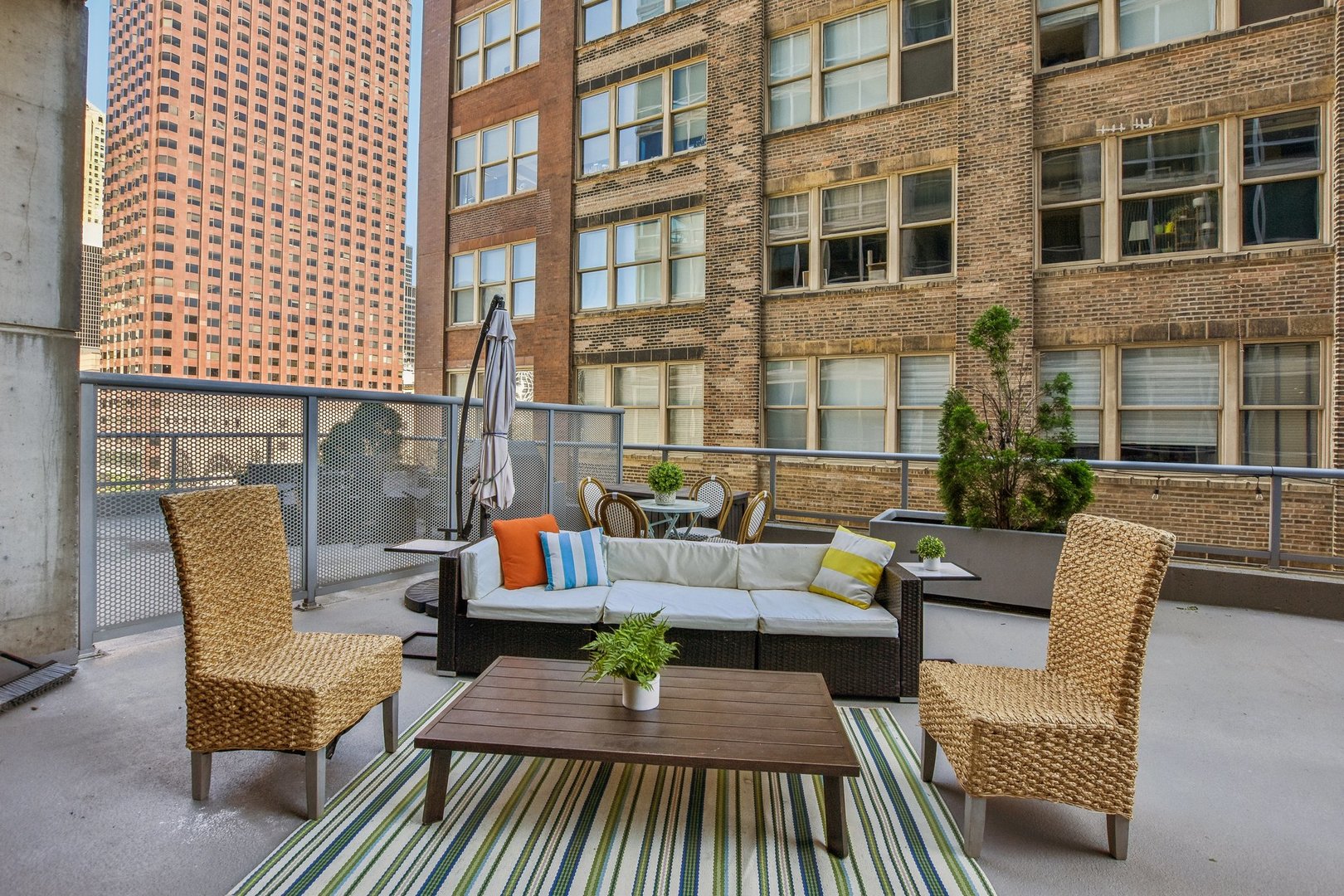 611 South Wells Street, Unit 702 Chicago, IL 60607 - Photo 21 of 32 a view of a patio with couches table and chairs and potted plants