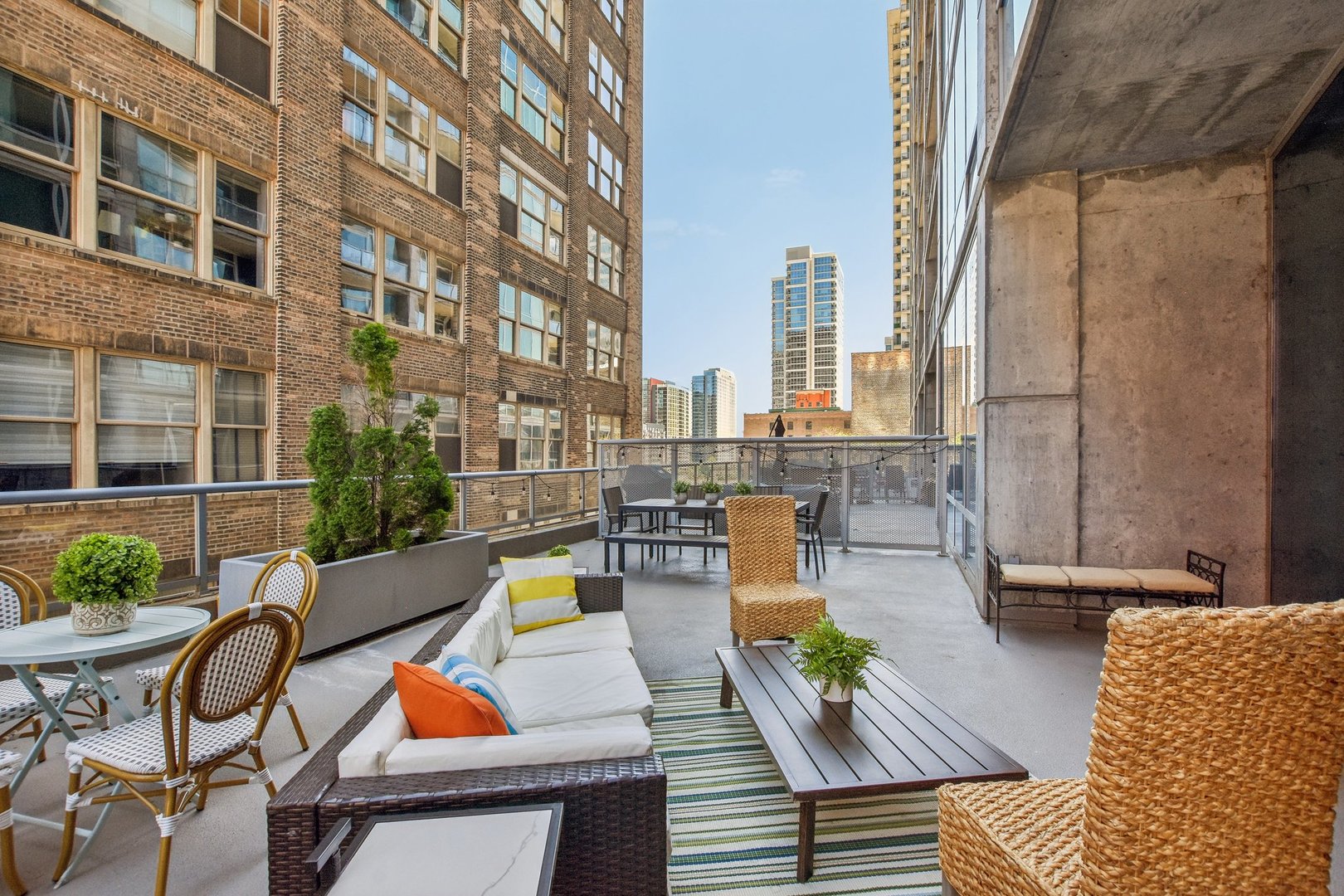 611 South Wells Street, Unit 702 Chicago, IL 60607 - Photo 22 of 32 a view of a patio with couches chairs and wooden floor
