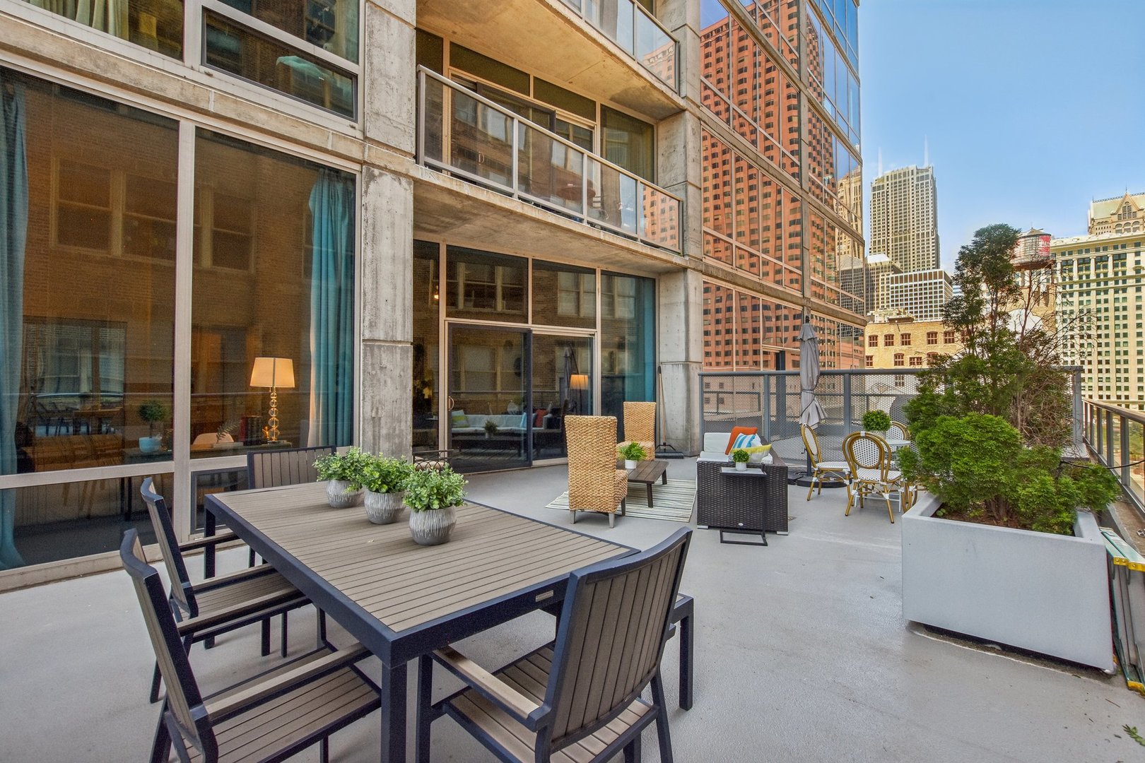 611 South Wells Street, Unit 702 Chicago, IL 60607 - Photo 3 of 32 a view of a patio with a table and chairs and potted plants
