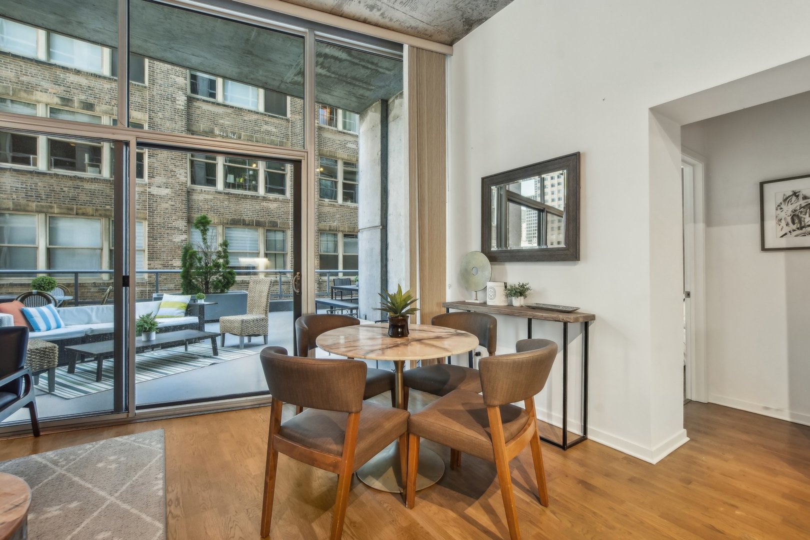 611 South Wells Street, Unit 702 Chicago, IL 60607 - Photo 5 of 32 a dining room with furniture and wooden floor