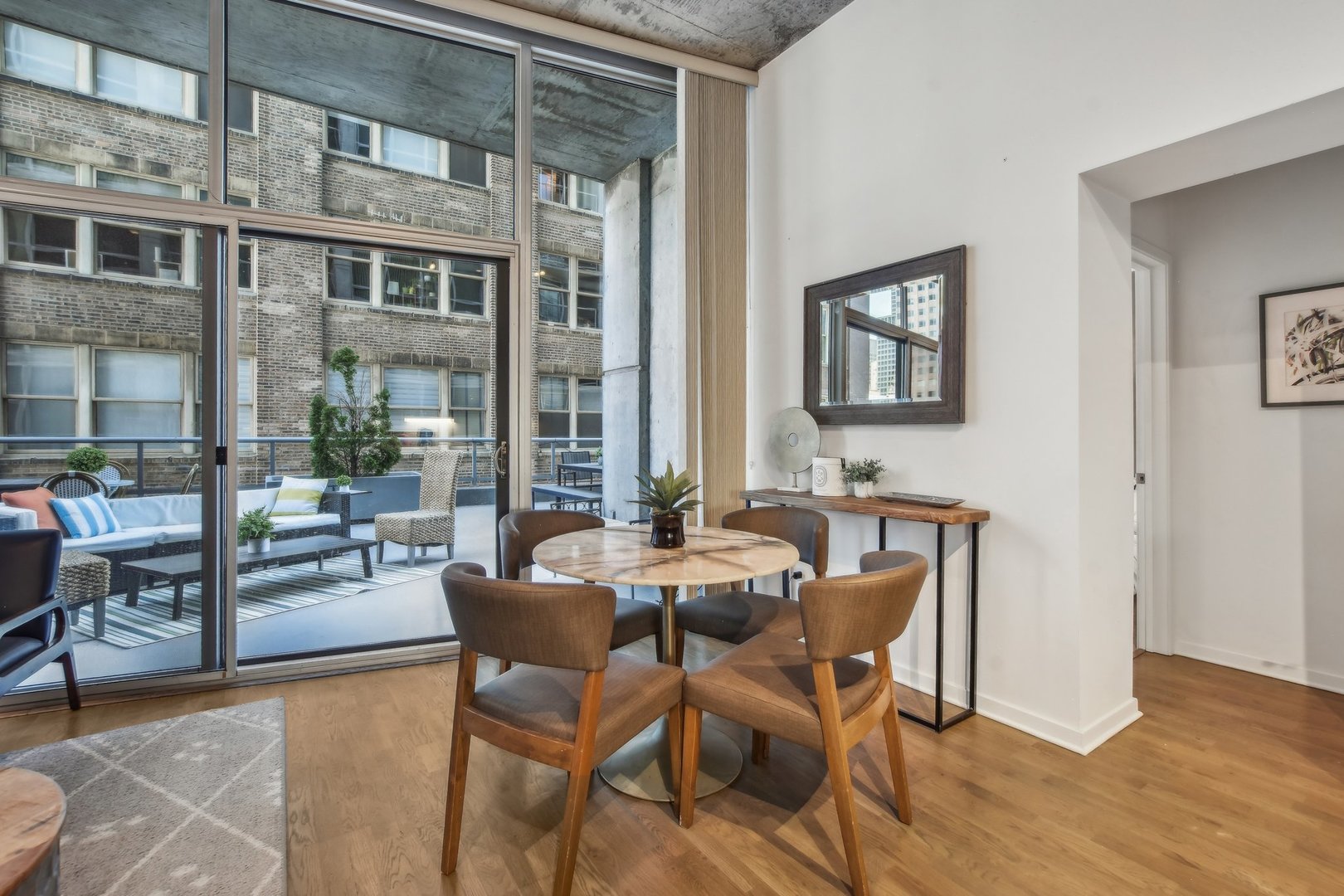 611 South Wells Street, Unit 702 Chicago, IL 60607 - Photo 6 of 32 a dining room with furniture and wooden floor