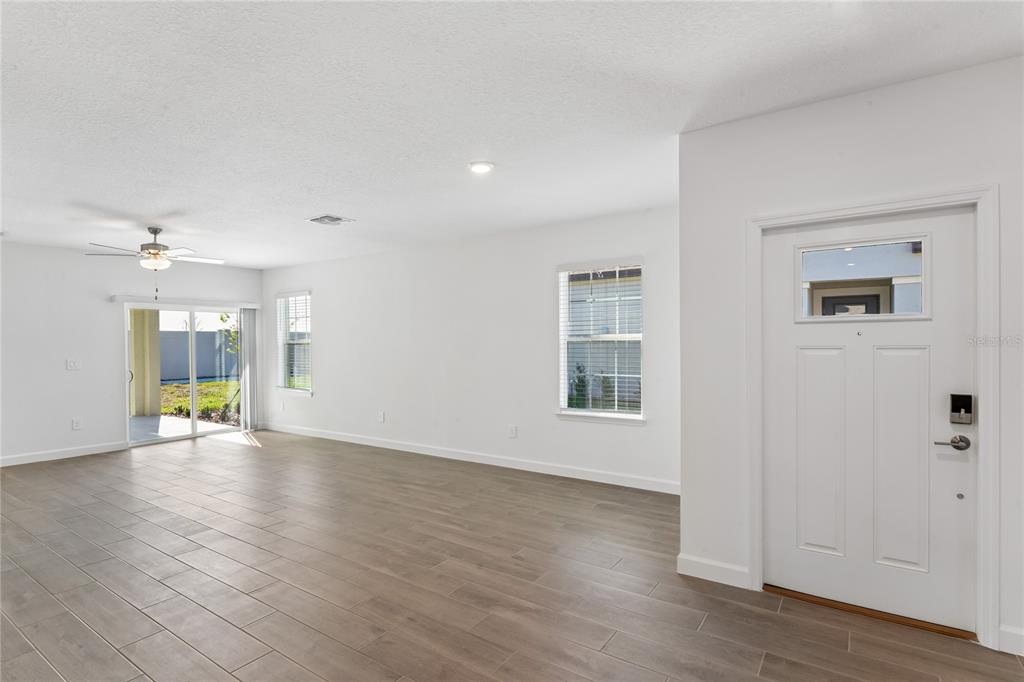 6692 Homebound Way New Port Richey, FL 34653 - Photo 8 of 47 wooden floor in an empty room with a window