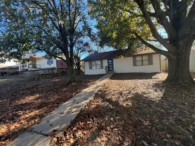 a house with a tree in front of it