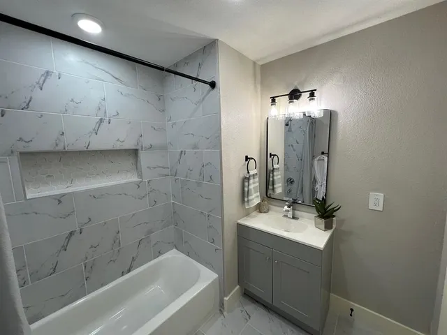 a kitchen with granite countertop a stove top oven sink and cabinets