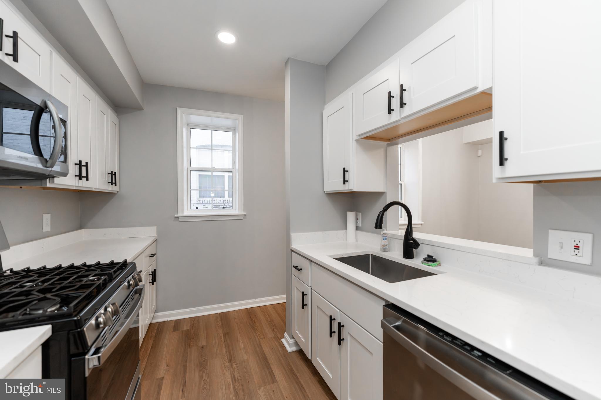 1008 Rittenhouse Street Northwest, Unit 15 Washington, DC 20011 - Photo 12 of 28 a kitchen that has a sink and a stove
