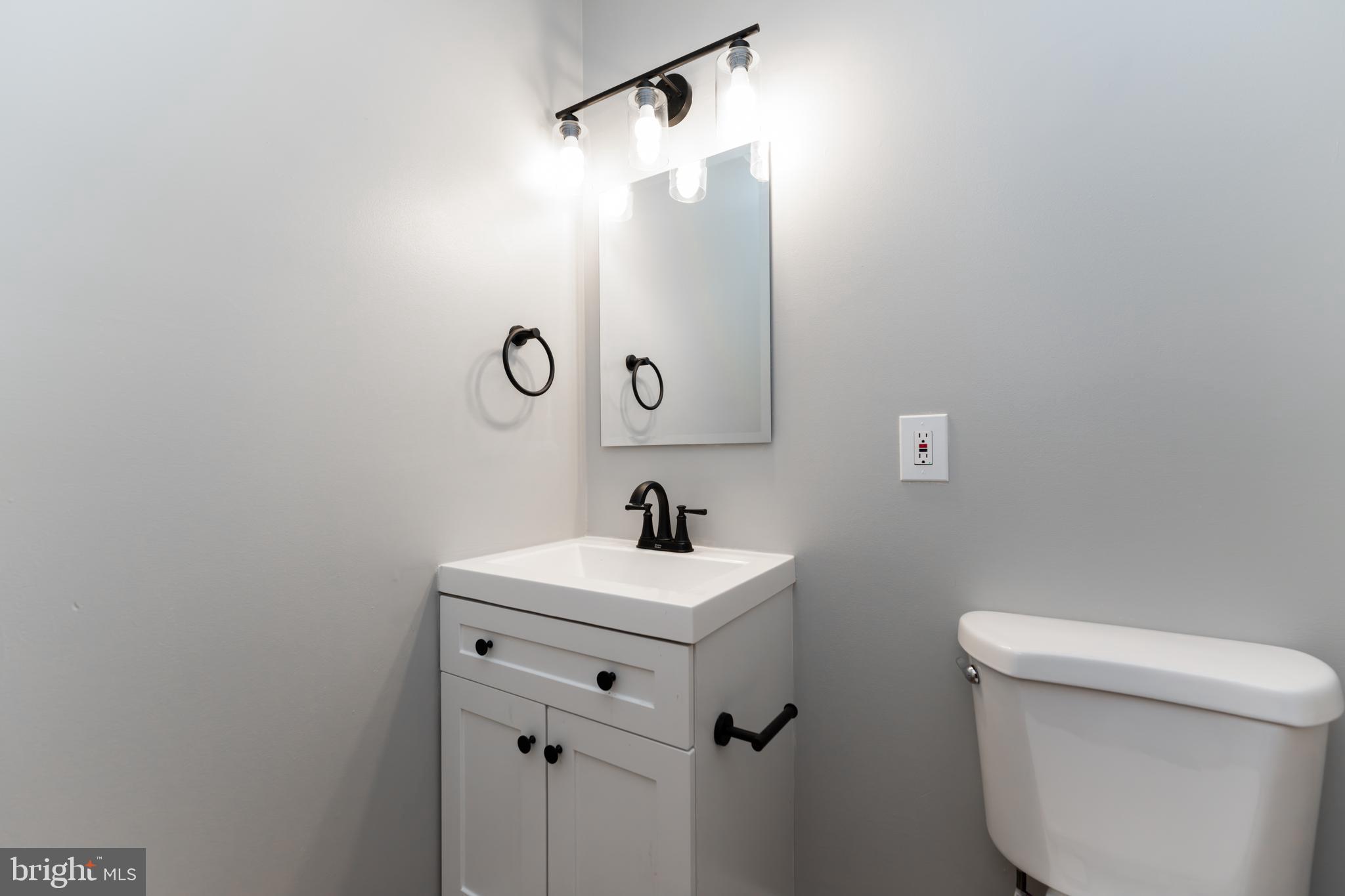 1008 Rittenhouse Street Northwest, Unit 15 Washington, DC 20011 - Photo 13 of 28 a bathroom with a sink mirror and toilet