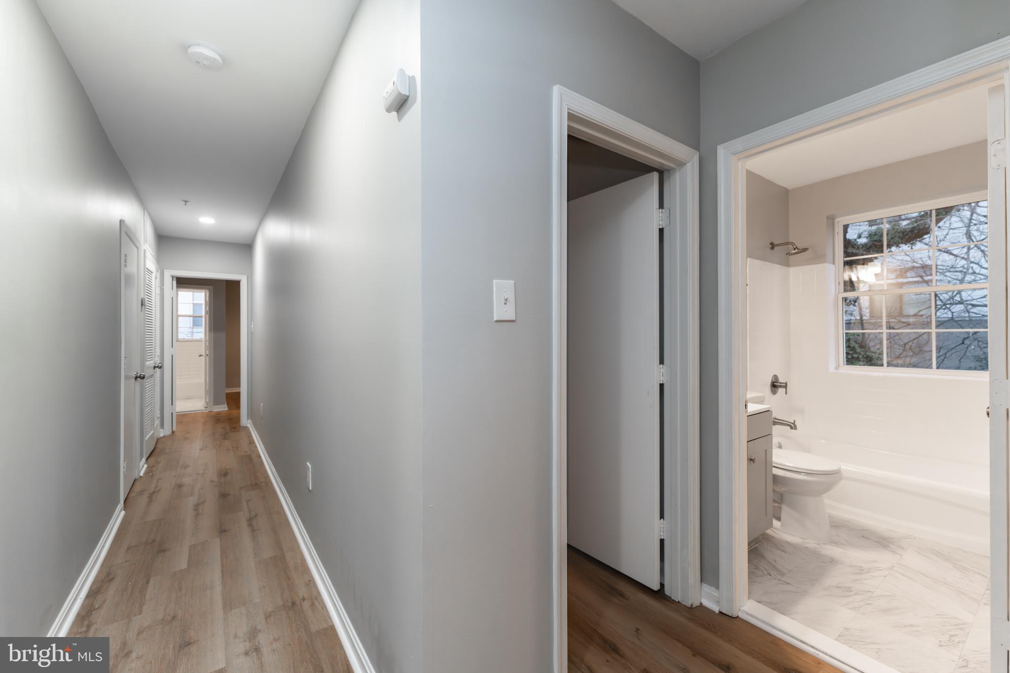 1008 Rittenhouse Street Northwest, Unit 15 Washington, DC 20011 - Photo 14 of 28 a view of a hallway with wooden floor and a bathroom
