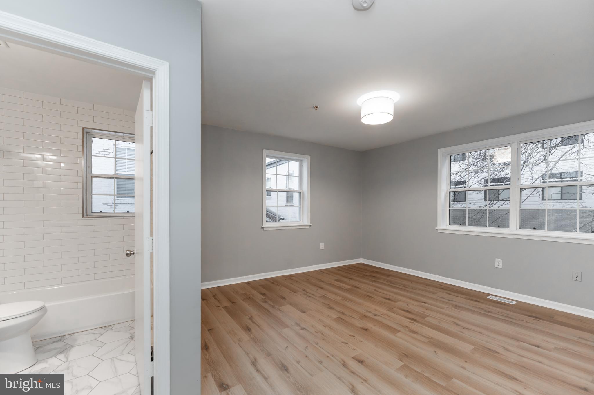 1008 Rittenhouse Street Northwest, Unit 15 Washington, DC 20011 - Photo 16 of 28 a view of a room with wooden floor and windows
