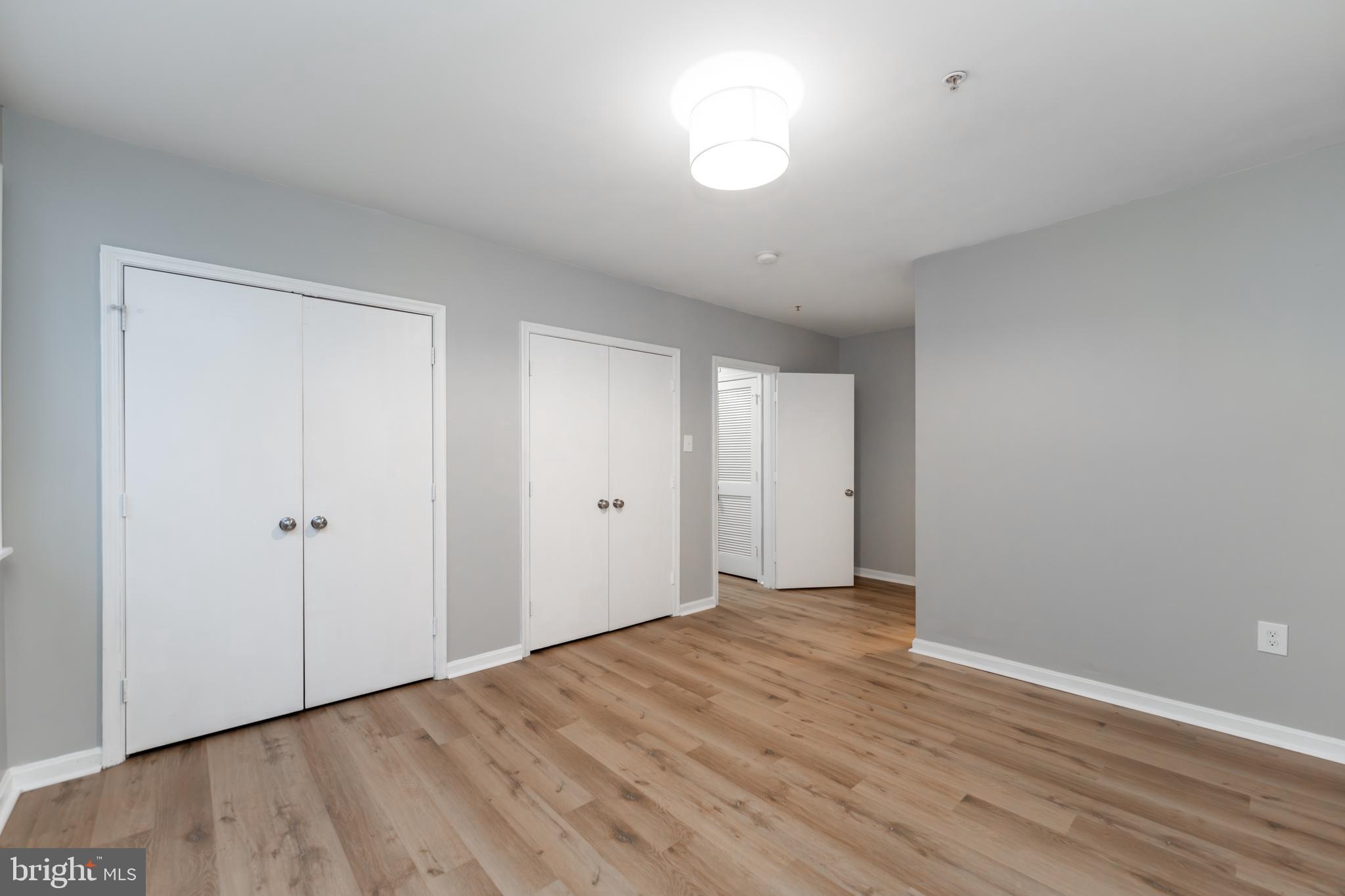1008 Rittenhouse Street Northwest, Unit 15 Washington, DC 20011 - Photo 18 of 28 a view of an empty room with wooden floor and a window