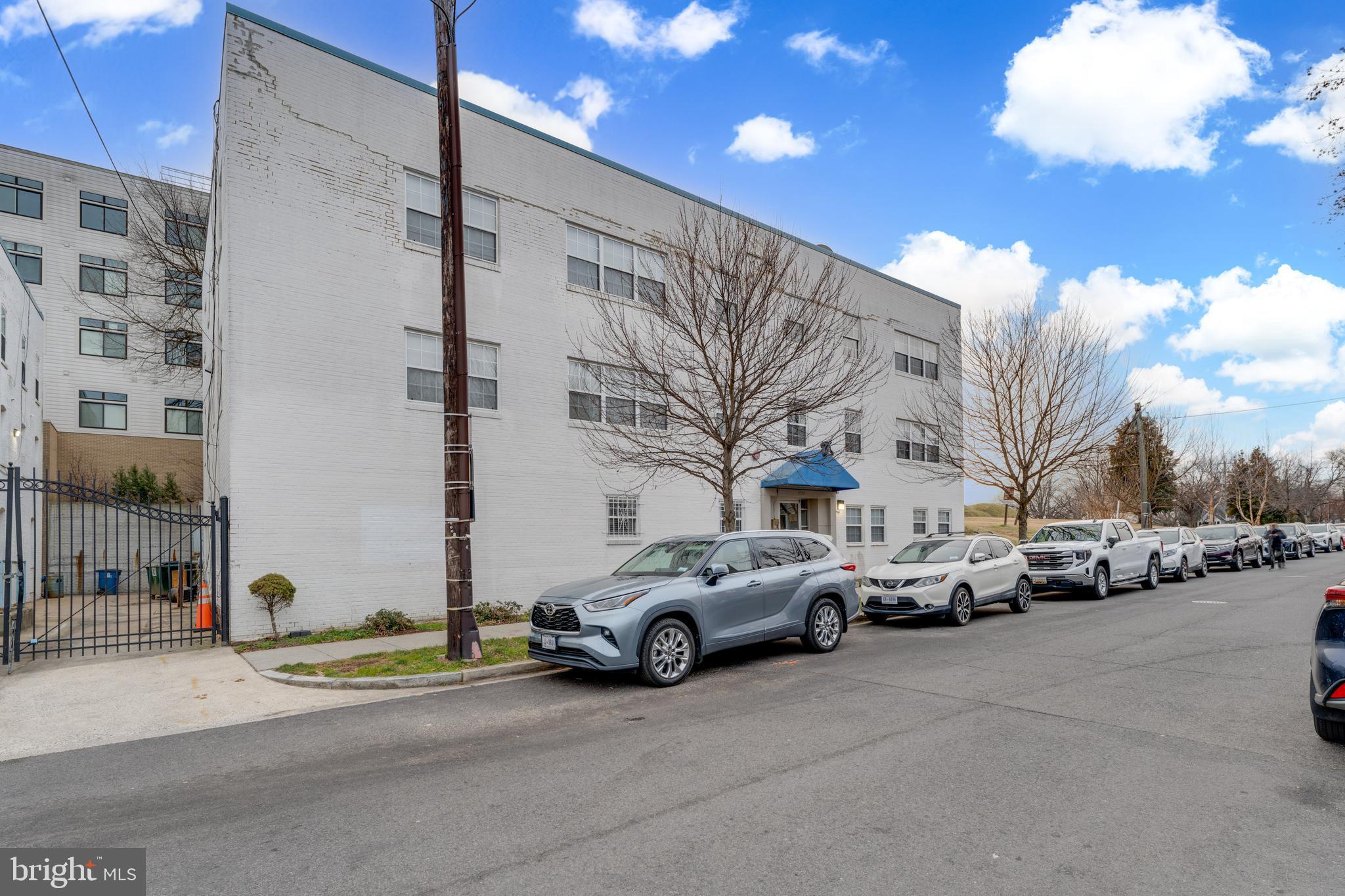 1008 Rittenhouse Street Northwest, Unit 15 Washington, DC 20011 - Photo 2 of 28 a view of a cars park in front of a building