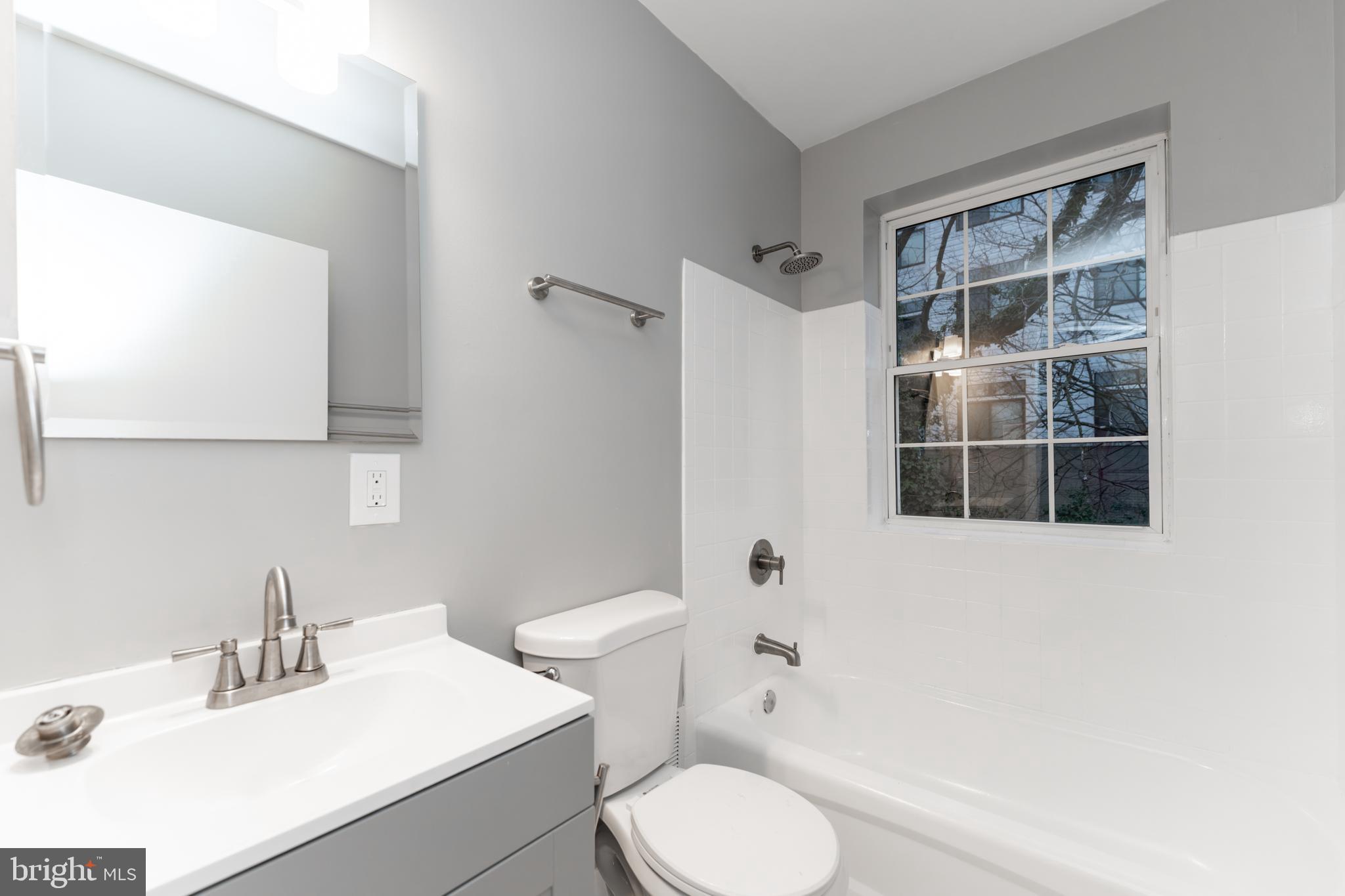 1008 Rittenhouse Street Northwest, Unit 15 Washington, DC 20011 - Photo 22 of 28 a bathroom with a sink toilet and shower