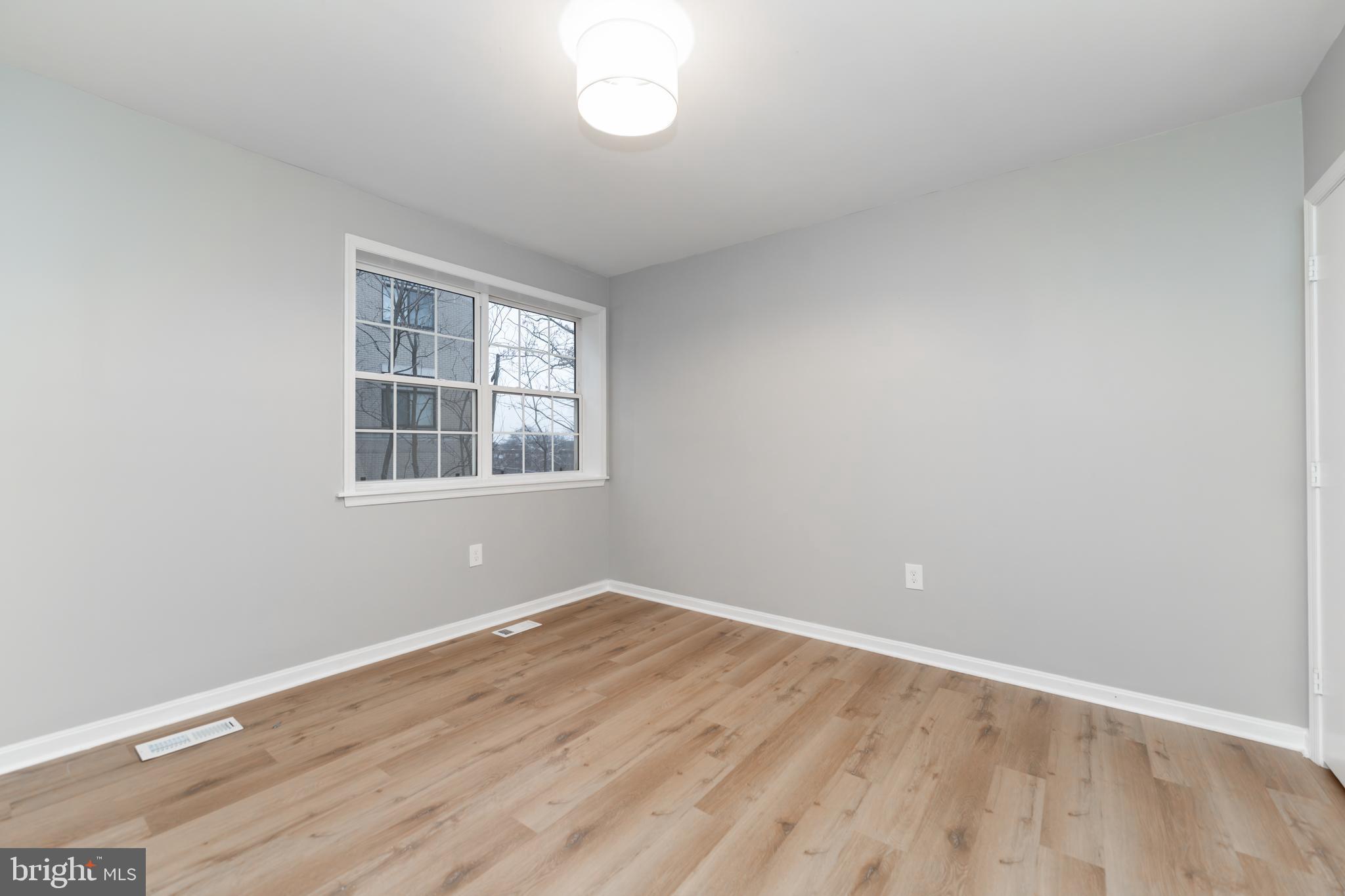 1008 Rittenhouse Street Northwest, Unit 15 Washington, DC 20011 - Photo 23 of 28 a view of empty room with wooden floor and fan