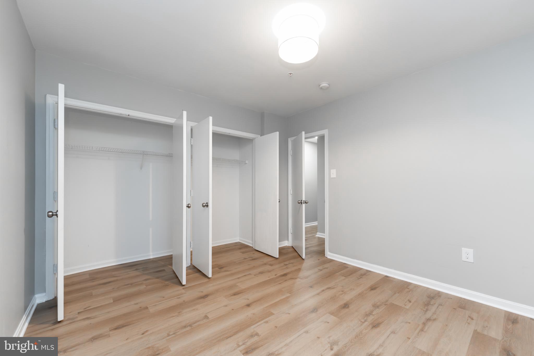 1008 Rittenhouse Street Northwest, Unit 15 Washington, DC 20011 - Photo 25 of 28 an empty room with wooden floor and window
