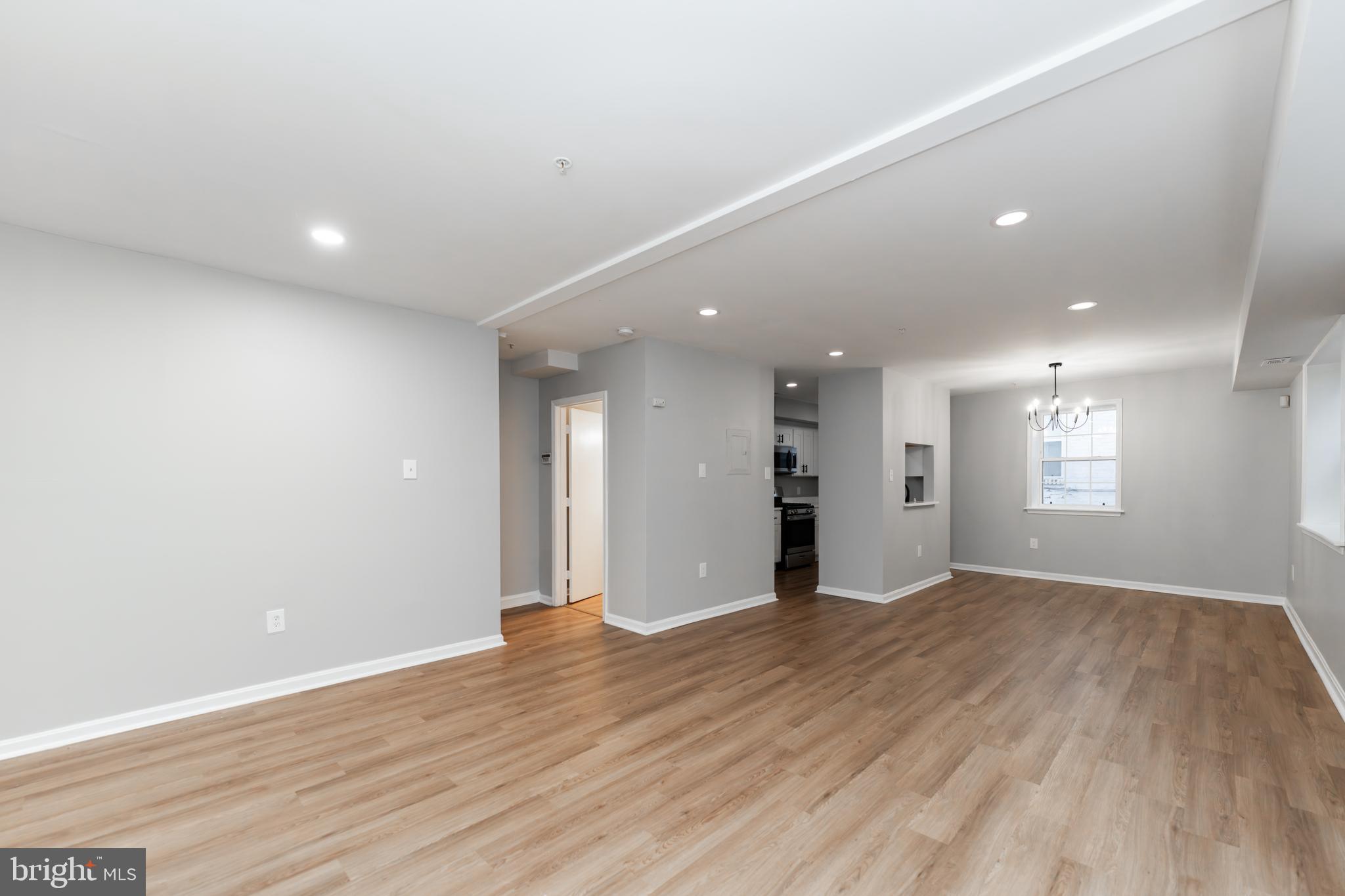 1008 Rittenhouse Street Northwest, Unit 15 Washington, DC 20011 - Photo 5 of 28 an empty room with wooden floor and windows