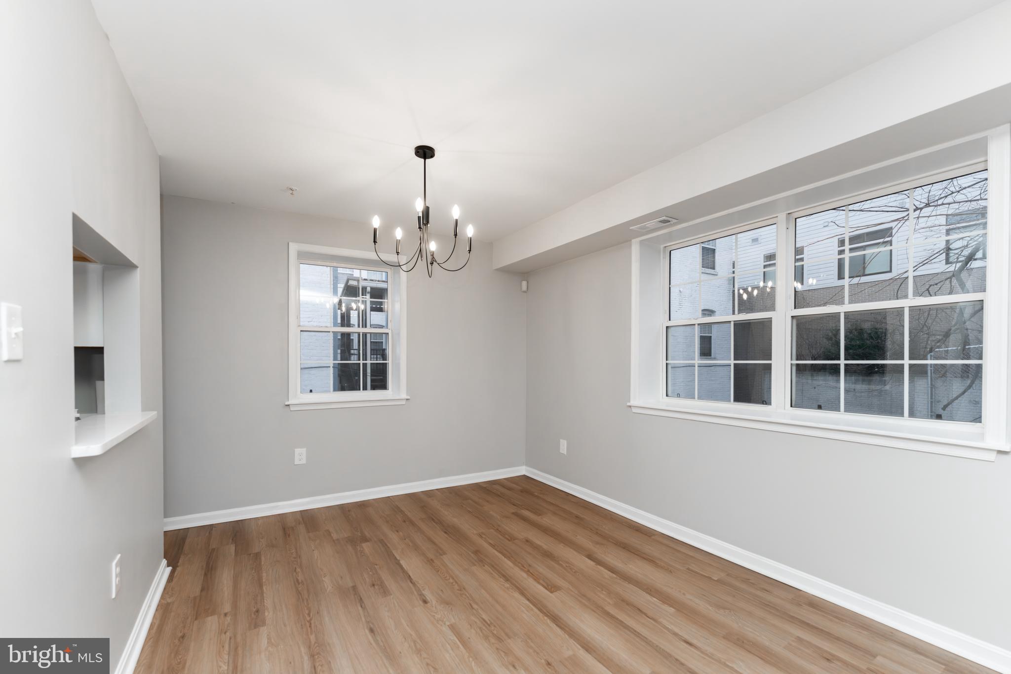 1008 Rittenhouse Street Northwest, Unit 15 Washington, DC 20011 - Photo 6 of 28 a view of empty room with wooden floor and fan