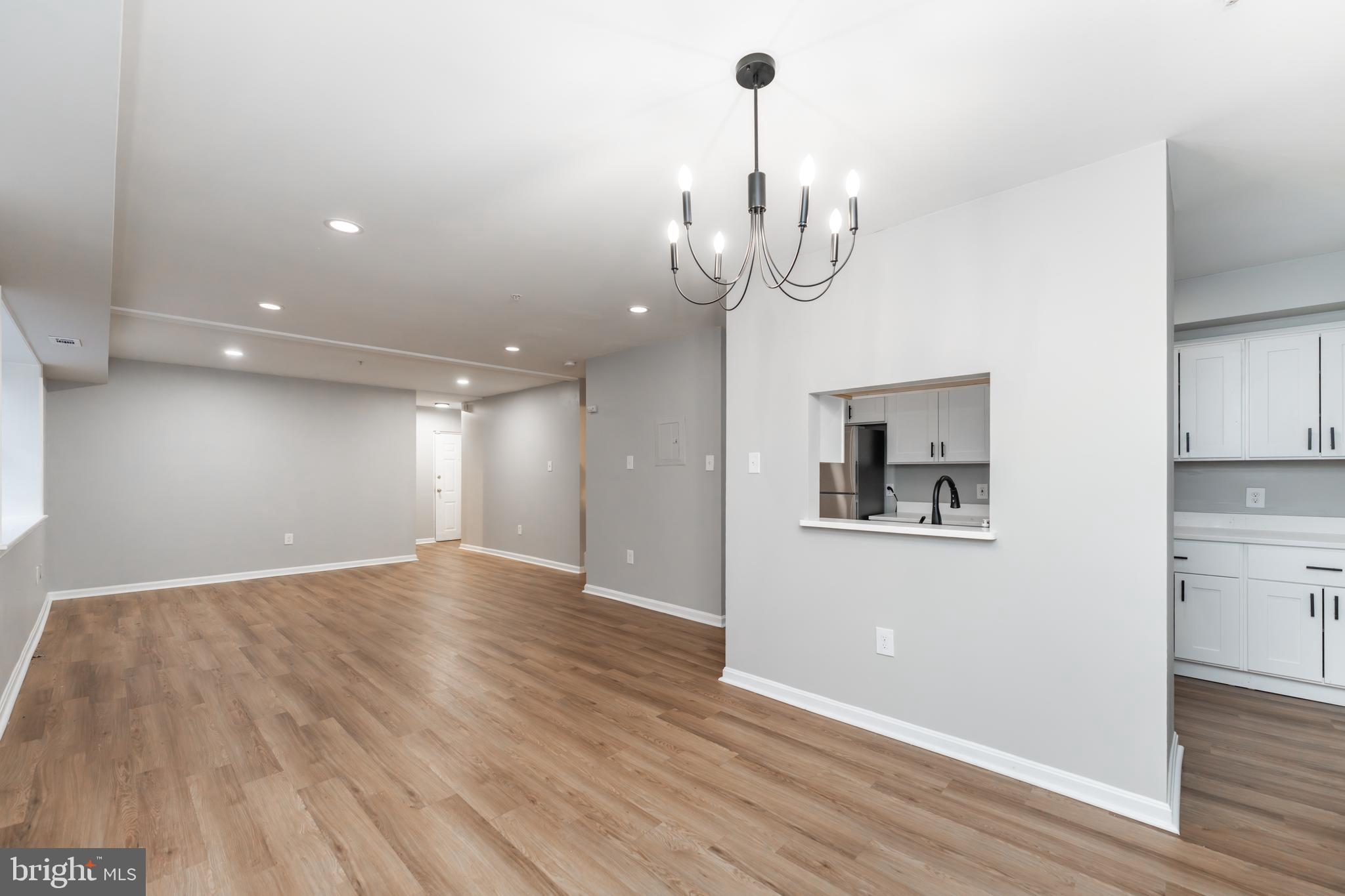 1008 Rittenhouse Street Northwest, Unit 15 Washington, DC 20011 - Photo 8 of 28 a view of a room with wooden floor and kitchen view