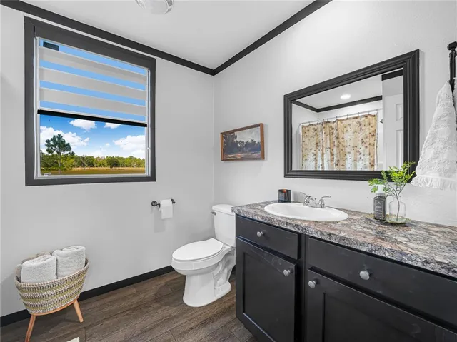 a view of a patio with dining table and chairs with wooden floor