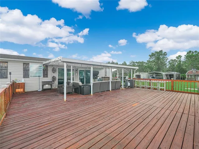 a view of a house with a yard and sitting area