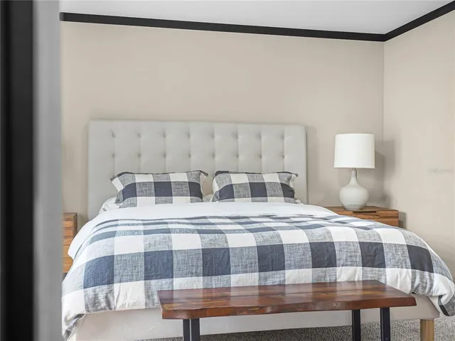 a large bathroom with a granite countertop double vanity sink a large mirror and a bathtub