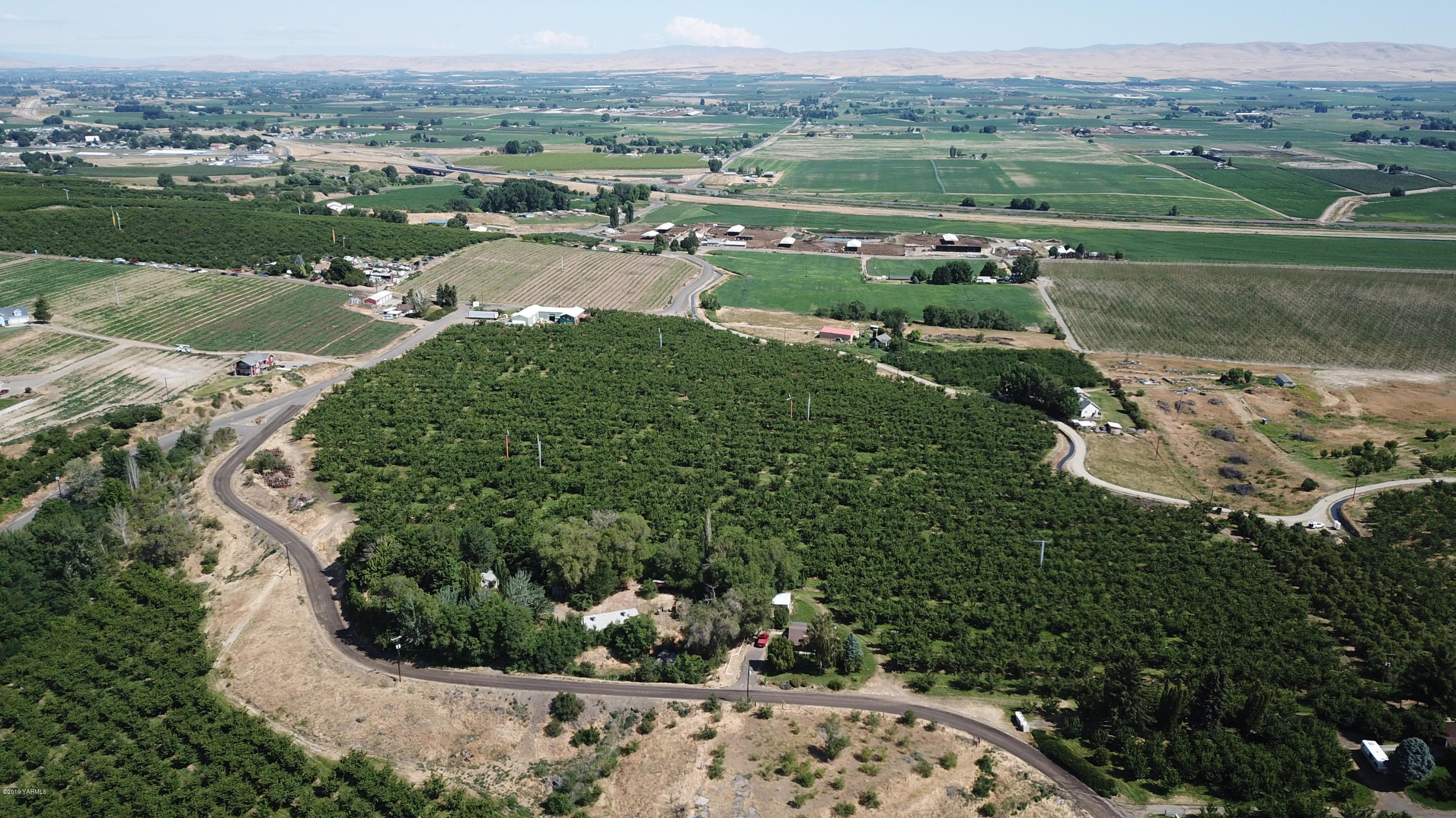 1711 Cherry Hill Road Granger, WA 98932 - Photo 4 of 5 an aerial view of a houses with a yard and lake view