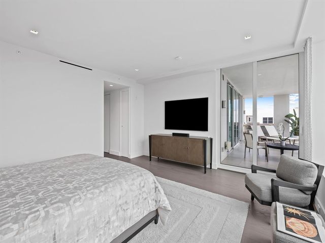 a view of a lake with a cars parked in front of a house