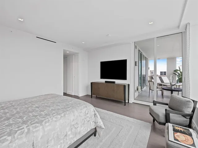 a view of a lake with a cars parked in front of a house