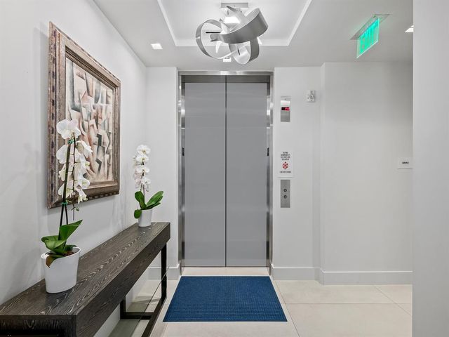 a view of a patio with lawn chairs