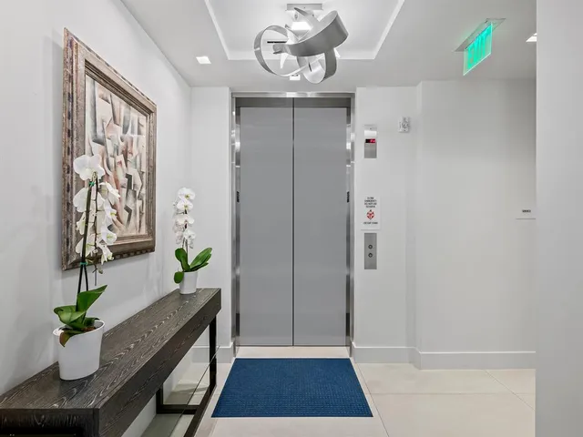 a view of a patio with lawn chairs