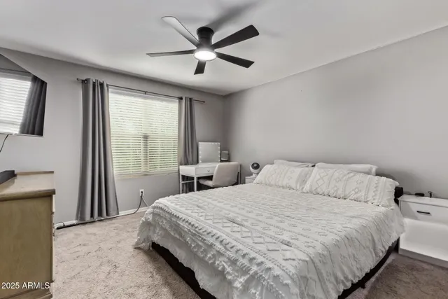 a bedroom with a large bed and a large window