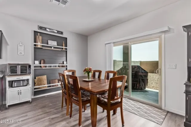 a dining room with furniture and wooden floor