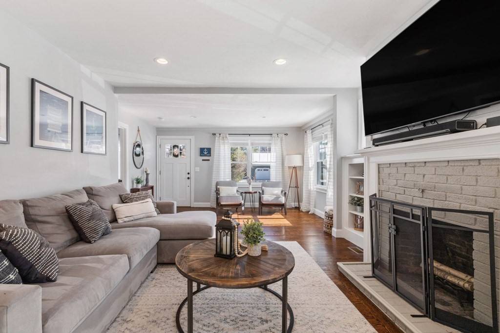 36 Eaton Road Framingham, MA 01701 - Photo 5 of 33 a living room with furniture a flat screen tv and a fireplace