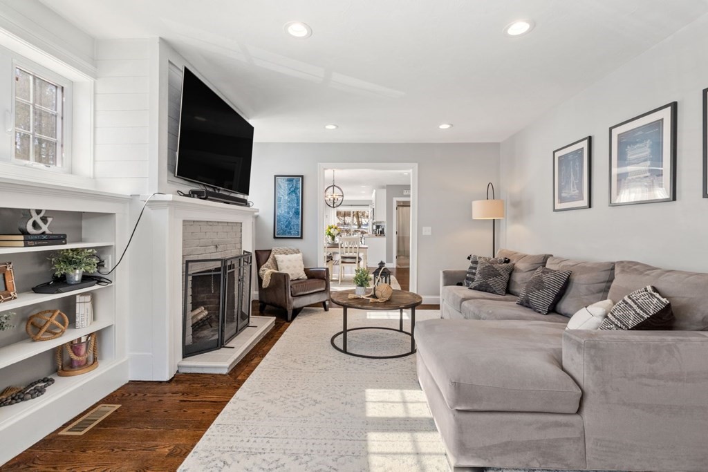 36 Eaton Road Framingham, MA 01701 - Photo 8 of 33 a living room with furniture a fireplace and a flat screen tv
