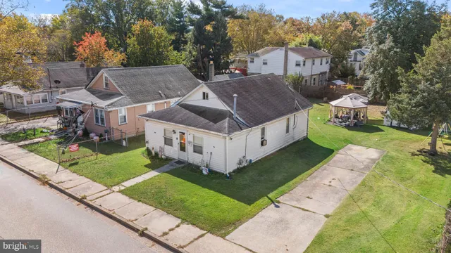 a aerial view of a house with a yard table and chairs