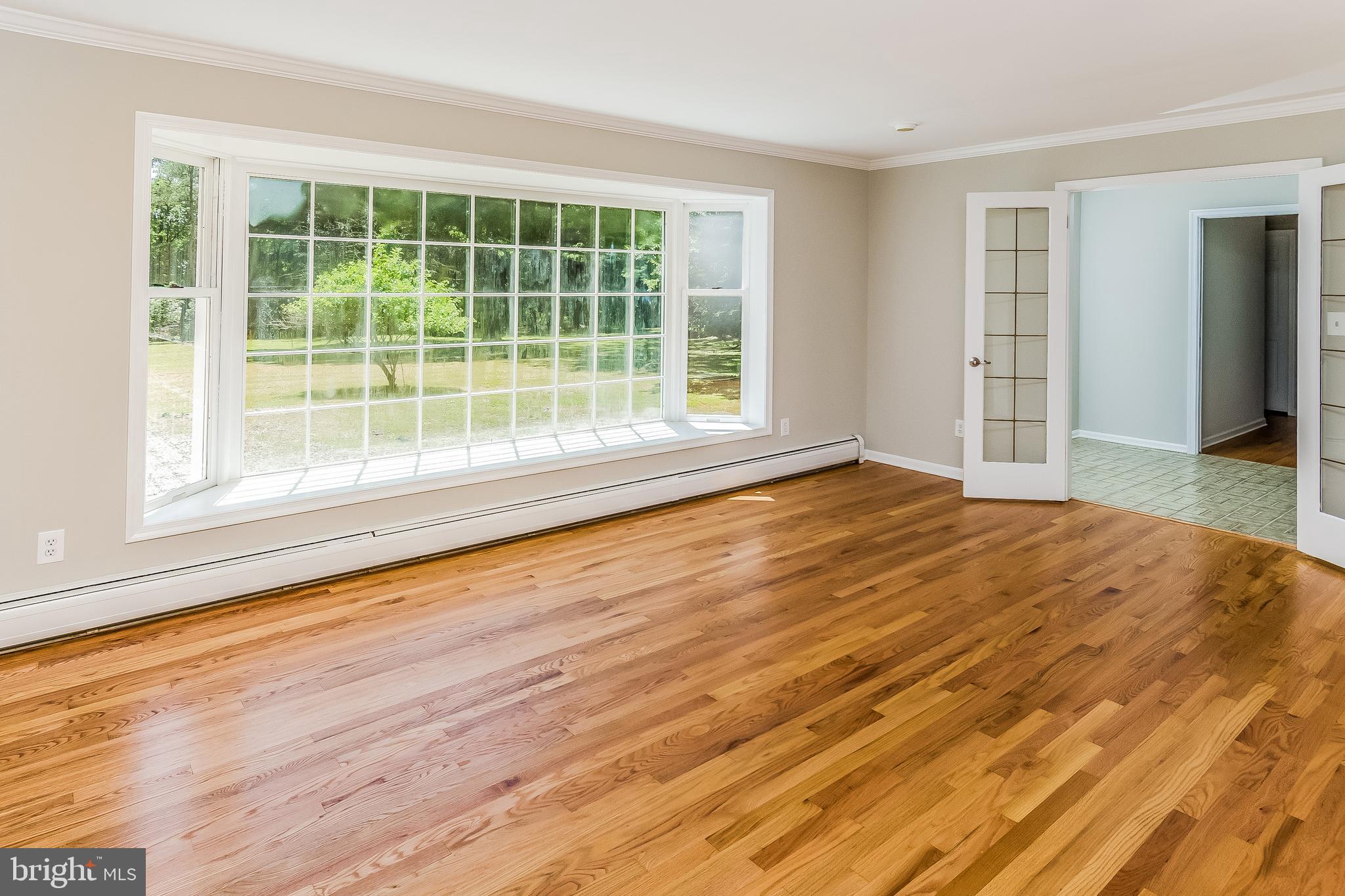 148 Lambertville Hopewell Road Hopewell, NJ 08525 - Photo 10 of 37 a view of empty room with wooden floor and fan