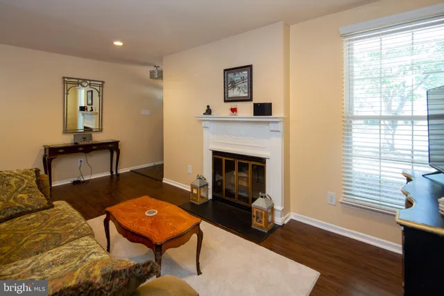 a living room with furniture a window and a fireplace