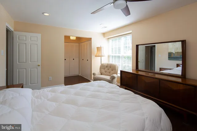 a bedroom with a bed and a large mirror