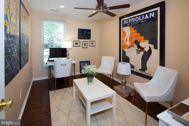 a living room with furniture a rug and a flat screen tv