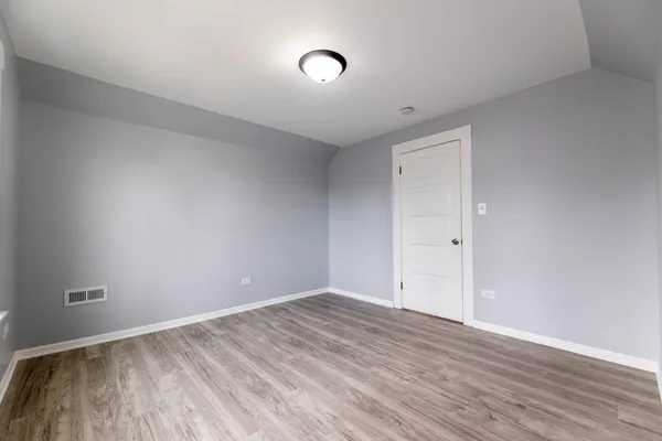 a view of room with wooden floor