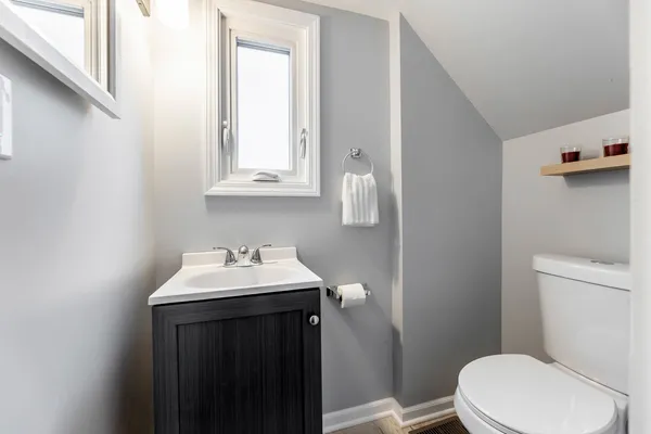a bathroom with a sink a toilet and mirror