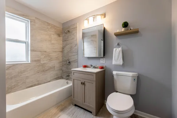 a white toilet sitting next to a bathroom sink