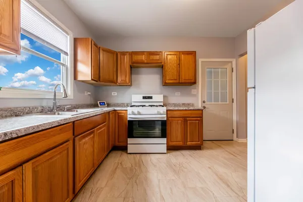 a kitchen with stainless steel appliances granite countertop a stove a sink and a microwave