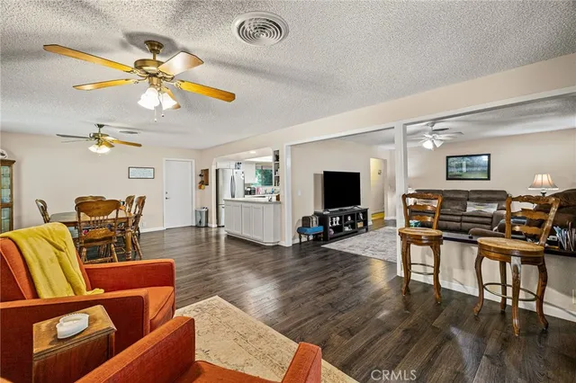 a living room with furniture and a flat screen tv with wooden floor