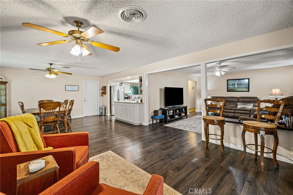 1270 East Eaton Road Chico, CA 95973 - Photo 7 of 9 a living room with furniture and a flat screen tv with wooden floor