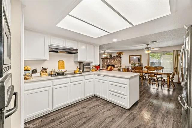 a kitchen with white cabinets and sink